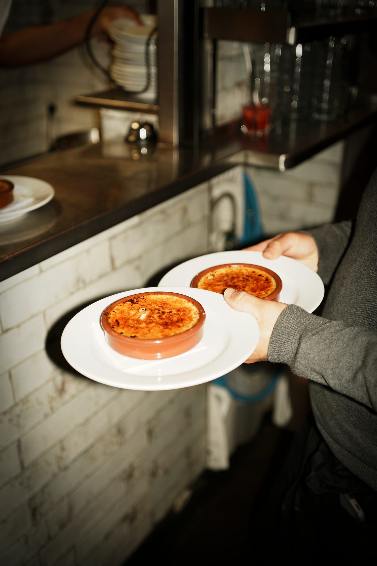 Two crèmes brûlées leaving the pass