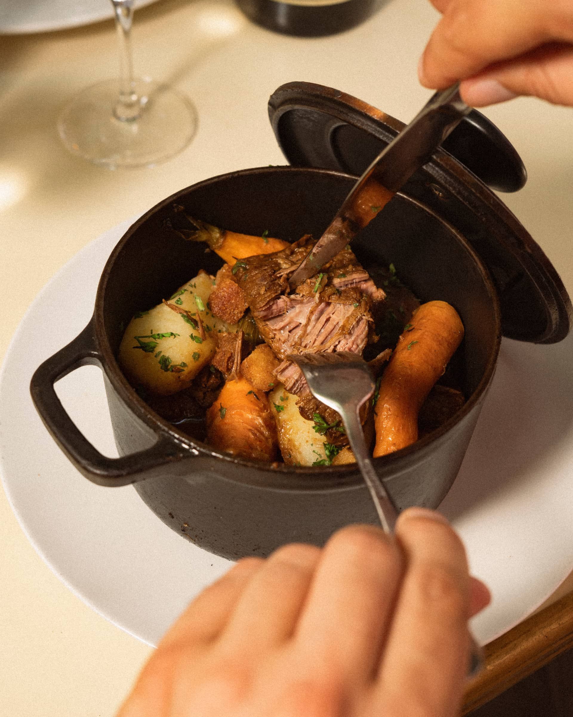 Beef and carrots in a casserole, served at the table